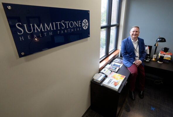Summitstone employee sitting in Office